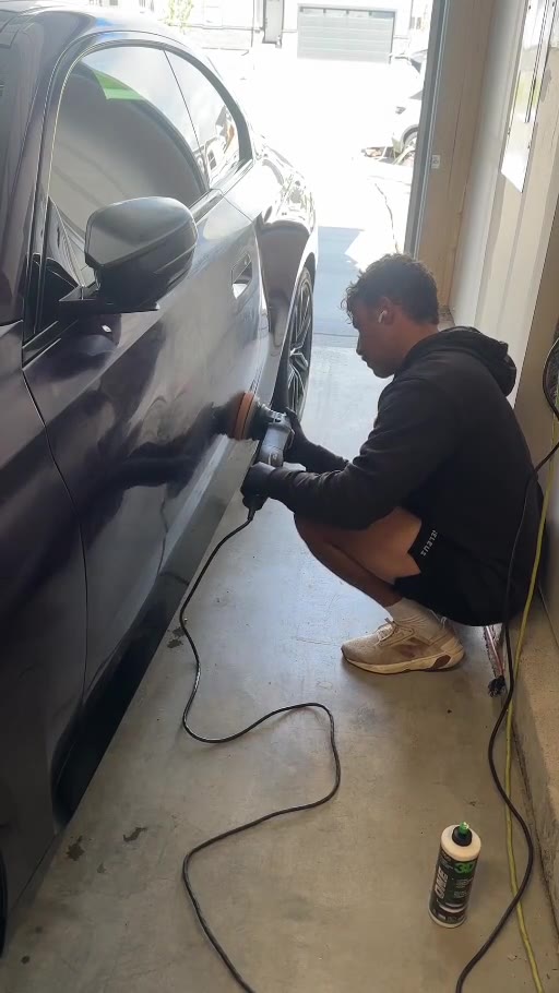 Paradeis Car Care technician machine polishing a vehicle door