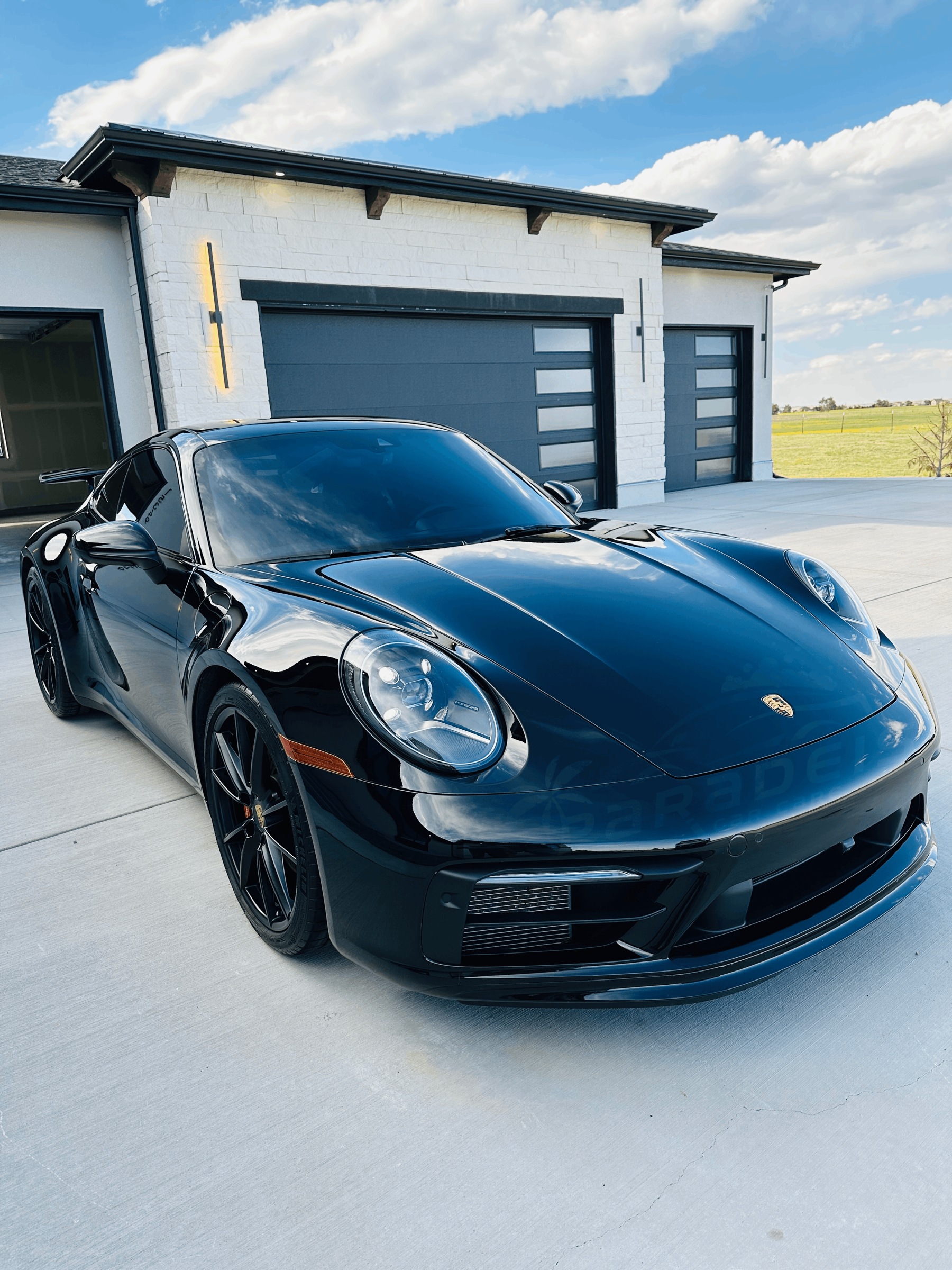 Black Porsche detailed by Paradeis Car Care, front three-quarter